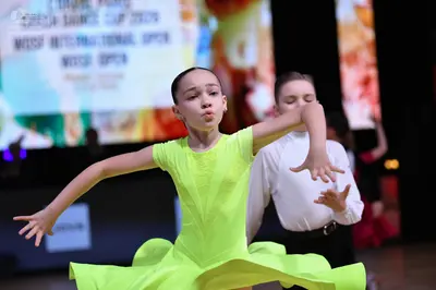 Dancesport competitor: Female dancer: lime green latin dress with a flared skirt