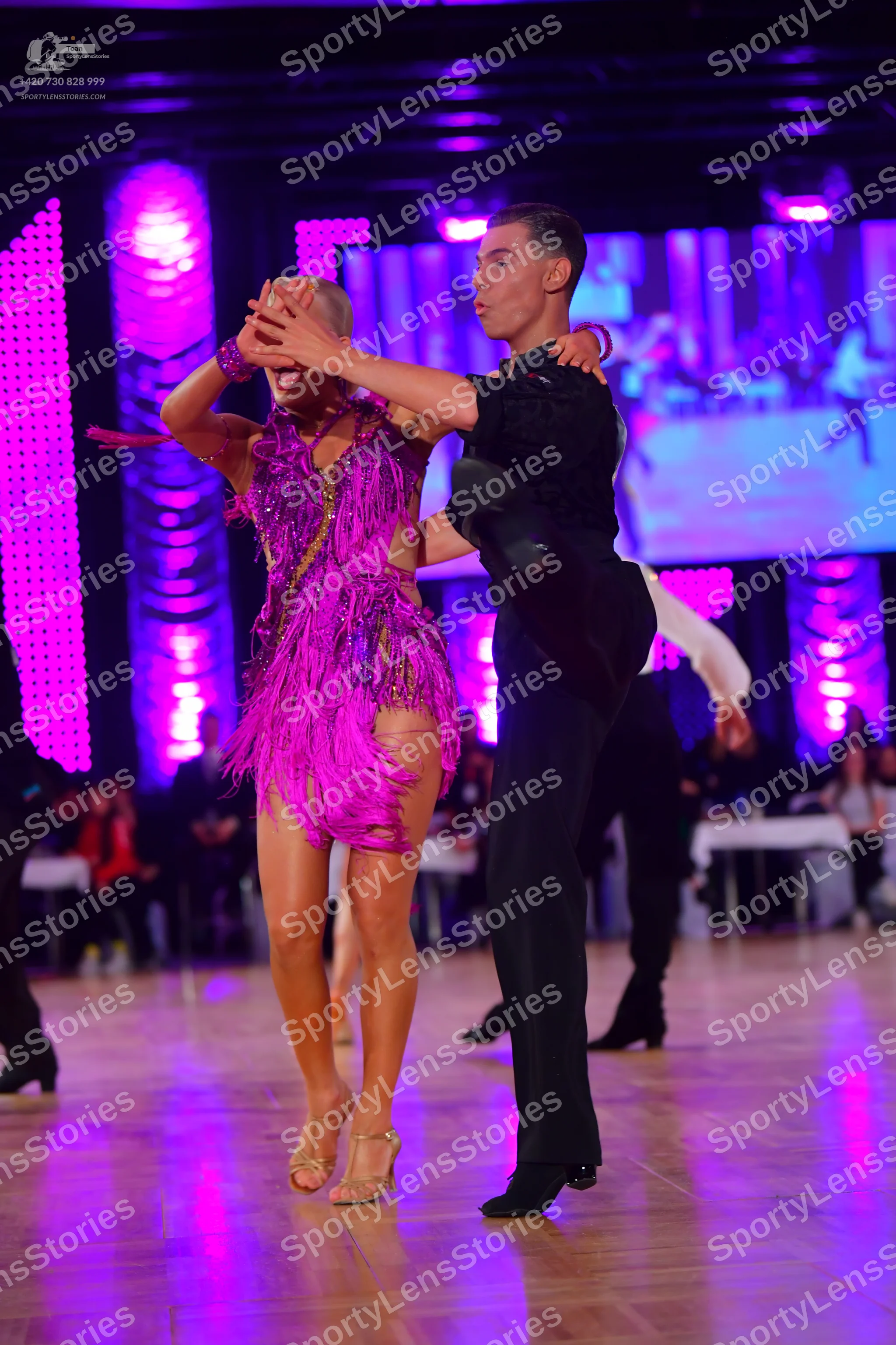 Dancesport competitor: Female dancer: purple latin dress with sequins and fringe