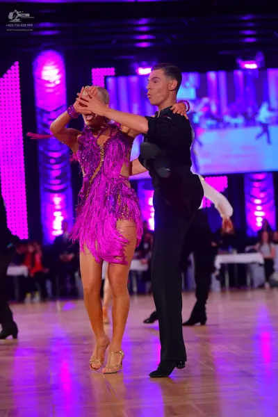 Dancesport competitor: Female dancer: purple latin dress with sequins and fringe