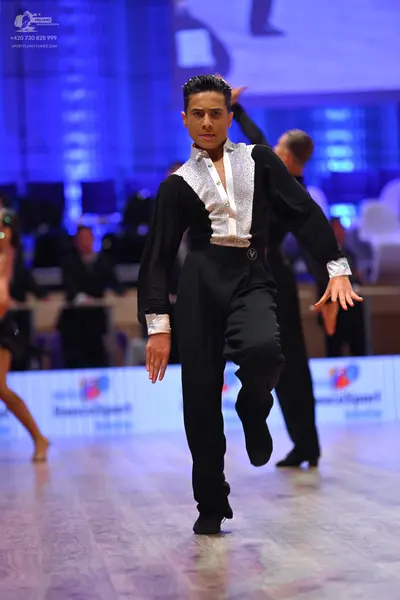 Dancesport competitor: Male dancer: black long-sleeved shirt with a shiny silver sequin front panel and