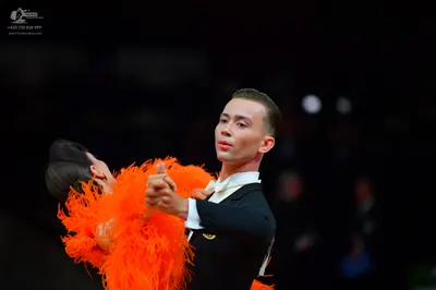 Dancesport competitor: Male dancer: black suit with a white collar