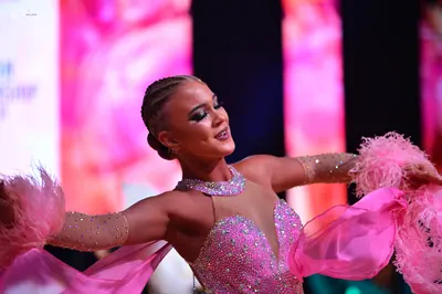 Dancesport competitor: Female dancer: light pink latin dress with a sequined bodice, sheer mesh necklin