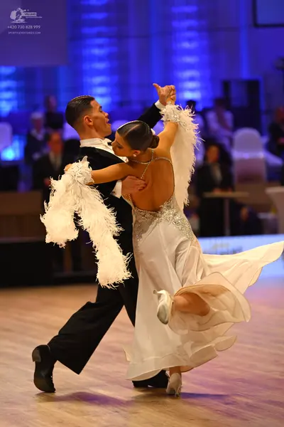 Dancesport competitor: Male dancer: black suit with a white shirt