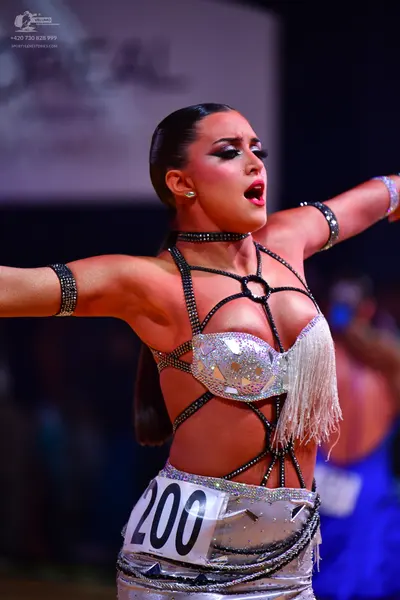 Dancesport competitor: Female dancer: silver sequined latin dress with thin straps and fringe