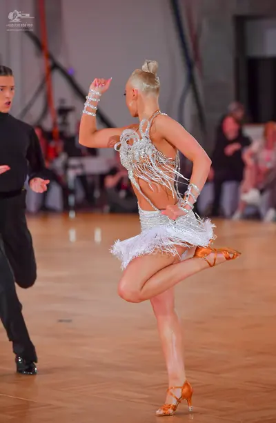 Dancesport competitor: Male dancer: black long-sleeved top