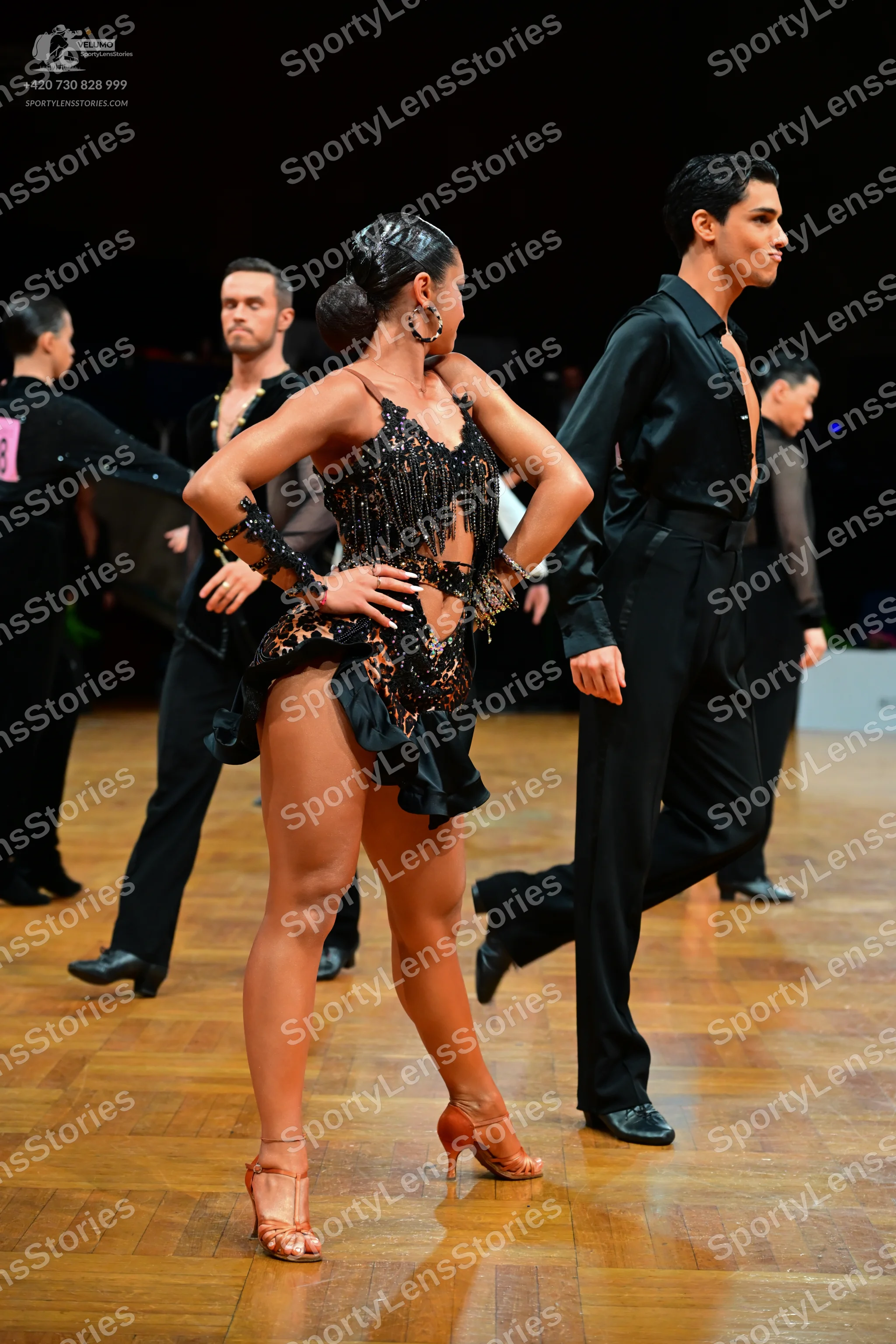 Dancesport competitor: Female dancer: black Latin dance dress with sequins, beads, and fringe