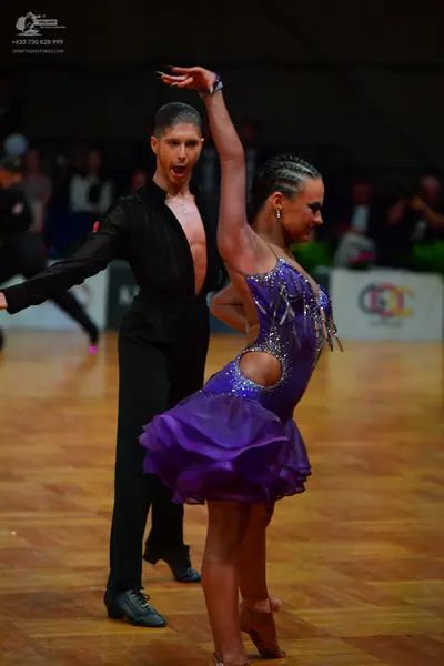 Dancesport competitor: Male dancer: black long-sleeved shirt and black trousers