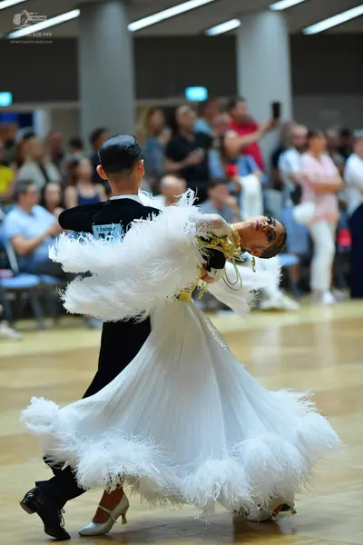Dancesport competitor: Male dancer: black long-sleeved dance shirt and black trousers