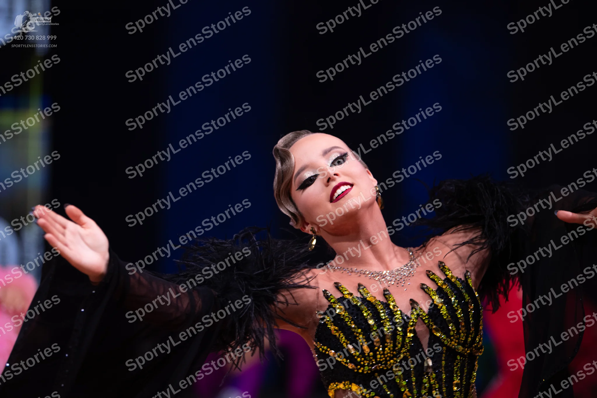 Dancesport competitor: Female dancer: black Latin dance dress with gold/yellow sequin and crystal embel