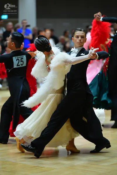 Dancesport competitor #25: Male dancer (left): black ballroom shirt and trousers