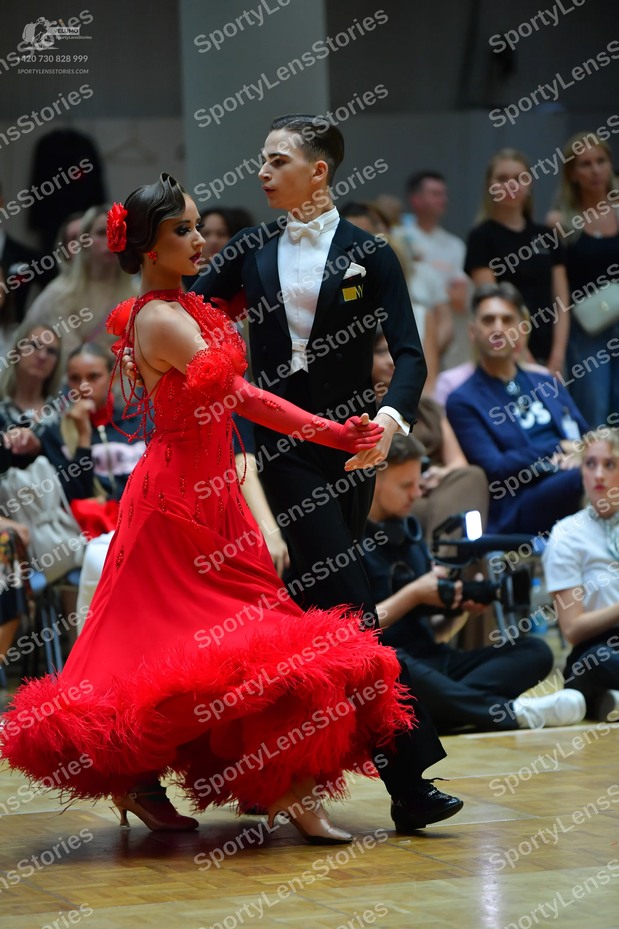 Dancesport competitor: Male dancer: black suit with a white shirt, white bowtie, and a white pocket squ