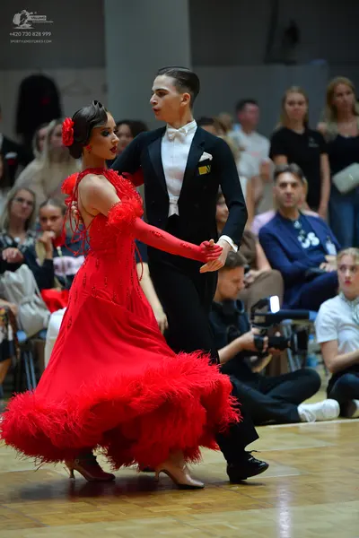 Dancesport competitor: Male dancer: black suit with a white shirt, white bowtie, and a white pocket squ