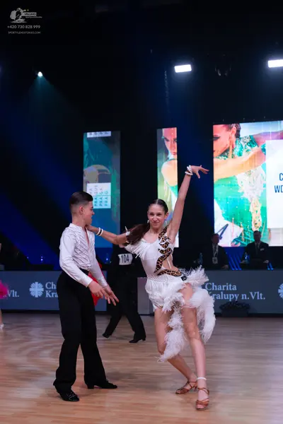 Dancesport competitor: Male dancer: white long-sleeved shirt and black trousers