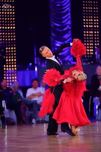 Dancesport competitor: Male dancer: black suit, white shirt, and black bow tie