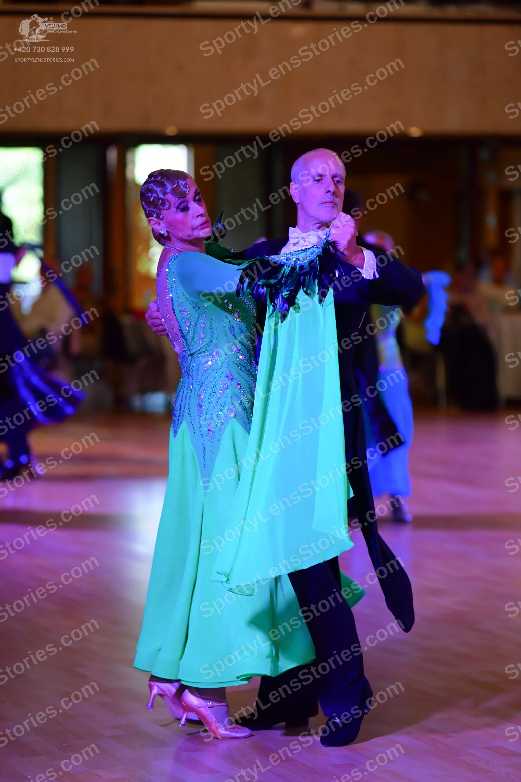 Dancesport competitor: Male:** Black tail suit with silver sequin lapels and a long, flowing black tail