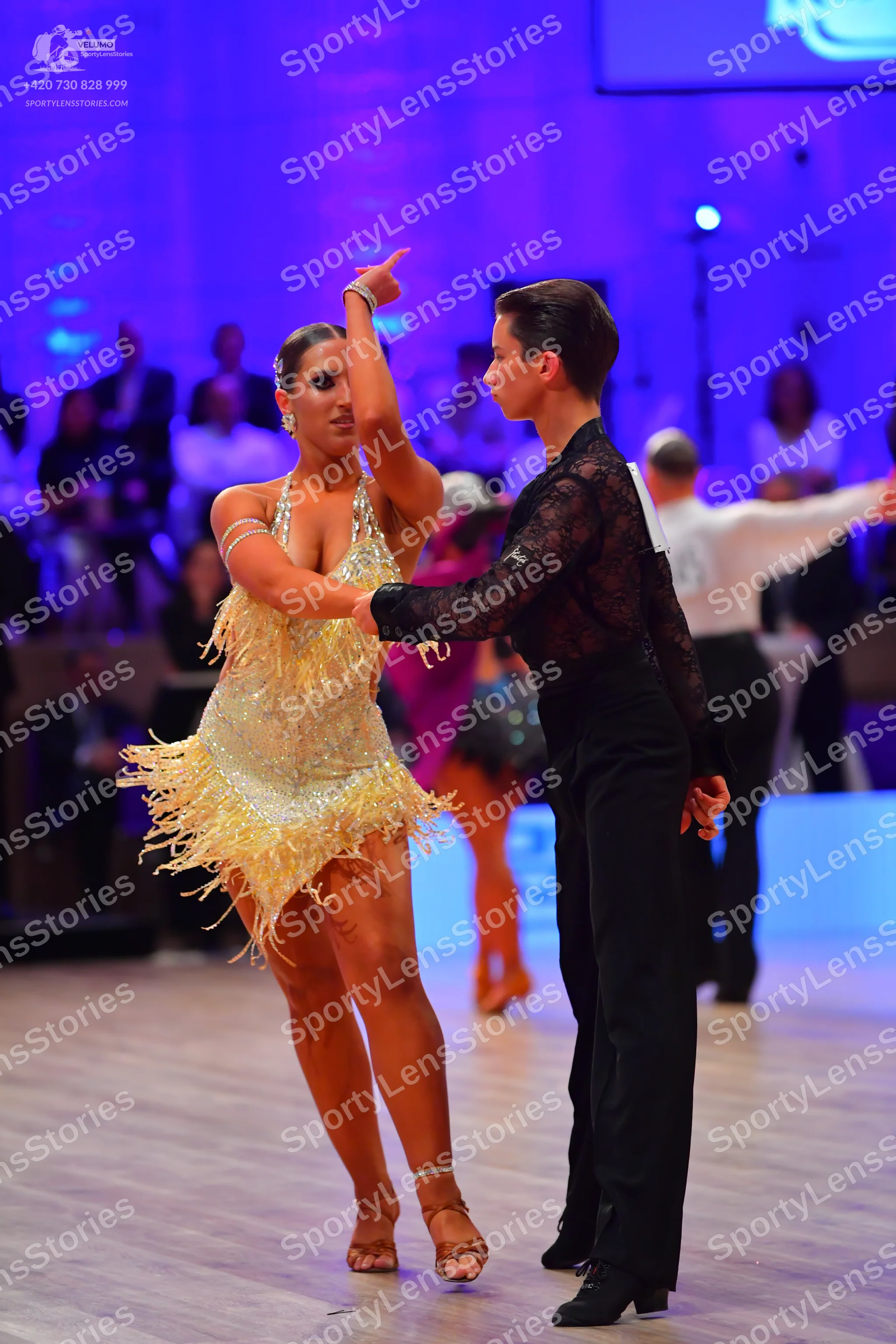 Dancesport competitor: Female dancer: pale yellow latin dress with sequins and long fringe
