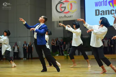 Dancesport competitor: Male dancer: blue patterned suit jacket and black trousers