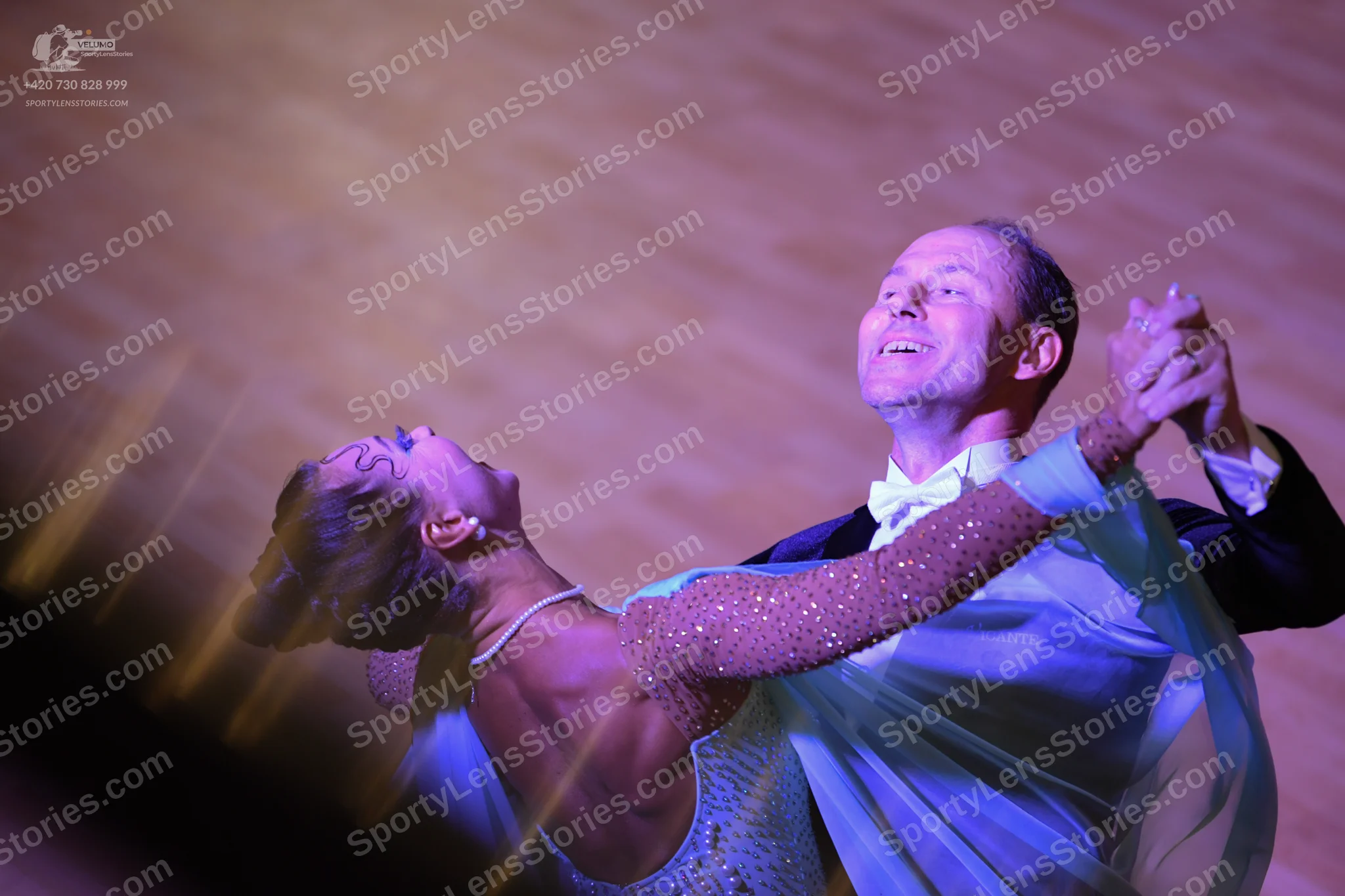 Dancesport competitor: Male dancer: black suit with a white shirt and white bow tie