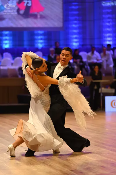 Dancesport competitor: Male dancer: black suit, white shirt, and white bowtie