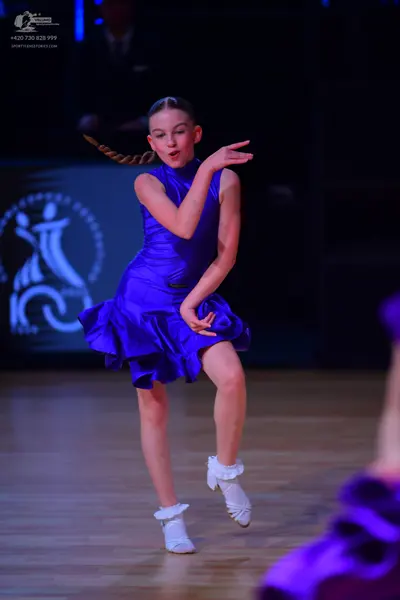 Dancesport competitor: Female dancer: royal blue satin-like Latin dance dress with a sleeveless top, hi