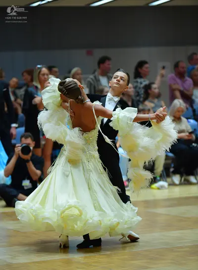 Dancesport competitor: Male dancer: black suit, white shirt, and black bow tie