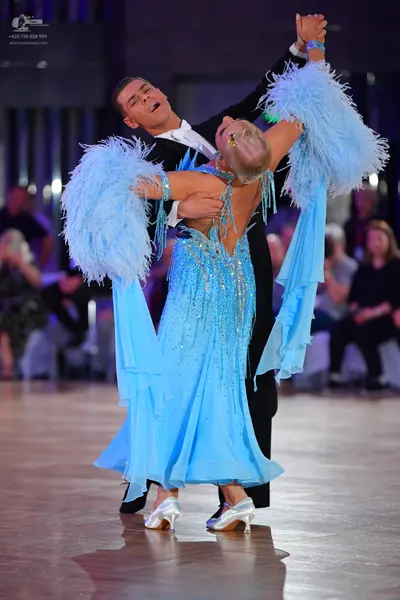 Dancesport competitor: Male dancer: black suit with a white shirt