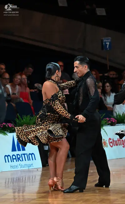 Dancesport competitor: Female dancer: leopard print mini latin dress with a flared skirt and tan dance 