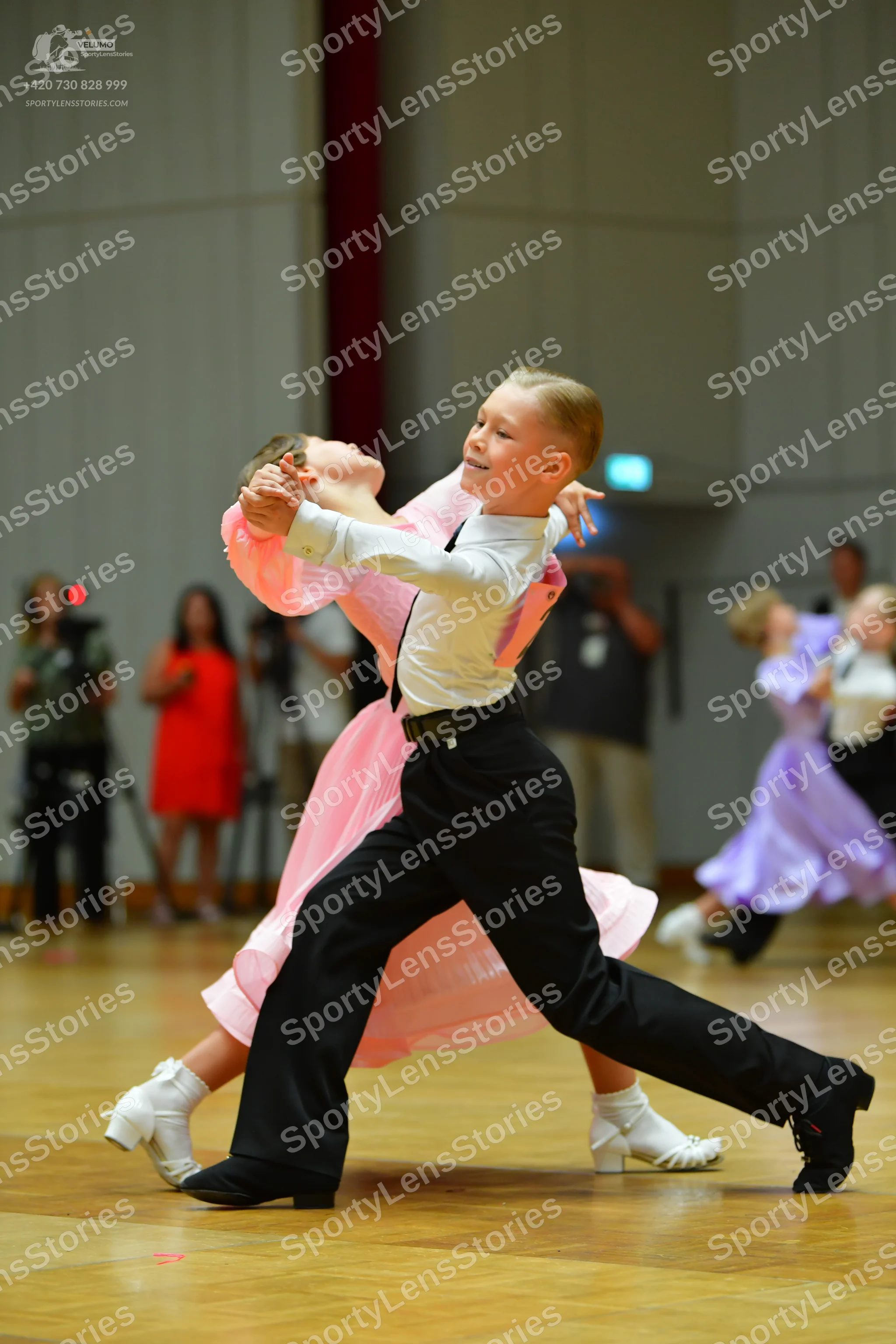 Dancesport competitor: Male dancer: white long-sleeved shirt, black waistcoat, and black trousers