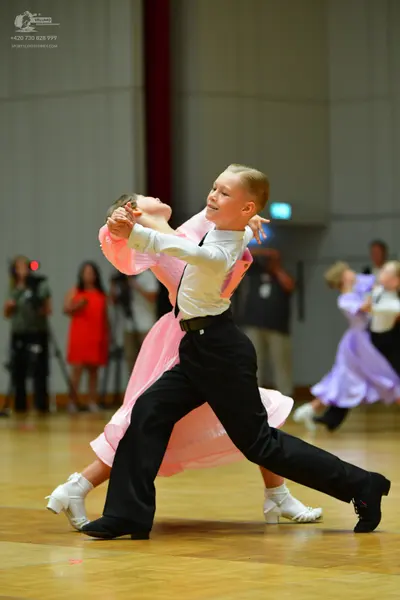 Dancesport competitor: Male dancer: white long-sleeved shirt, black waistcoat, and black trousers