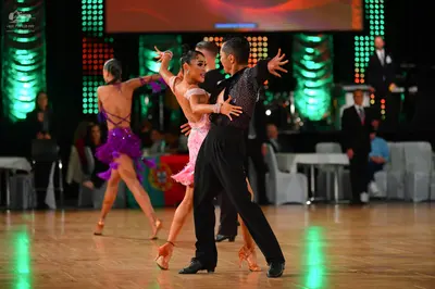 Dancesport competitor: Female dancer 1: purple Latin dress with thin straps