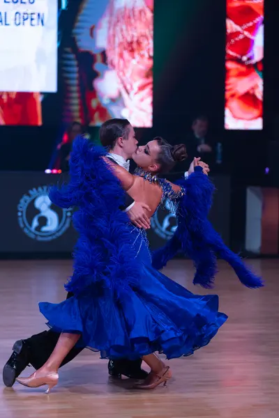 Dancesport competitor: Male dancer: black suit with a white shirt