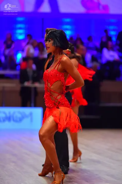Dancesport competitor: Female dancer: red latin dress with sequins and red fringe