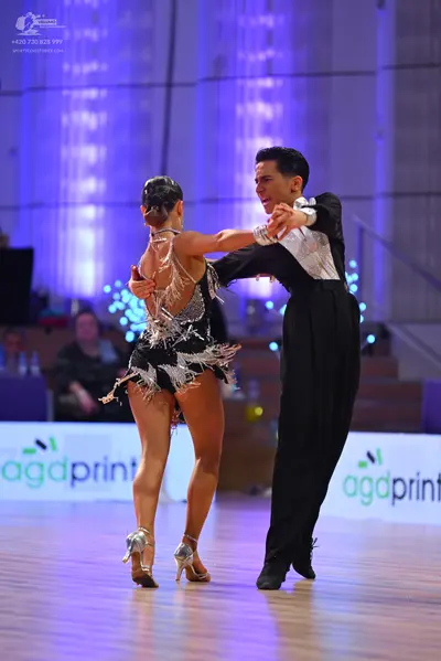 Dancesport competitor: Female dancer: black latin dress with silver sequins and fringe
