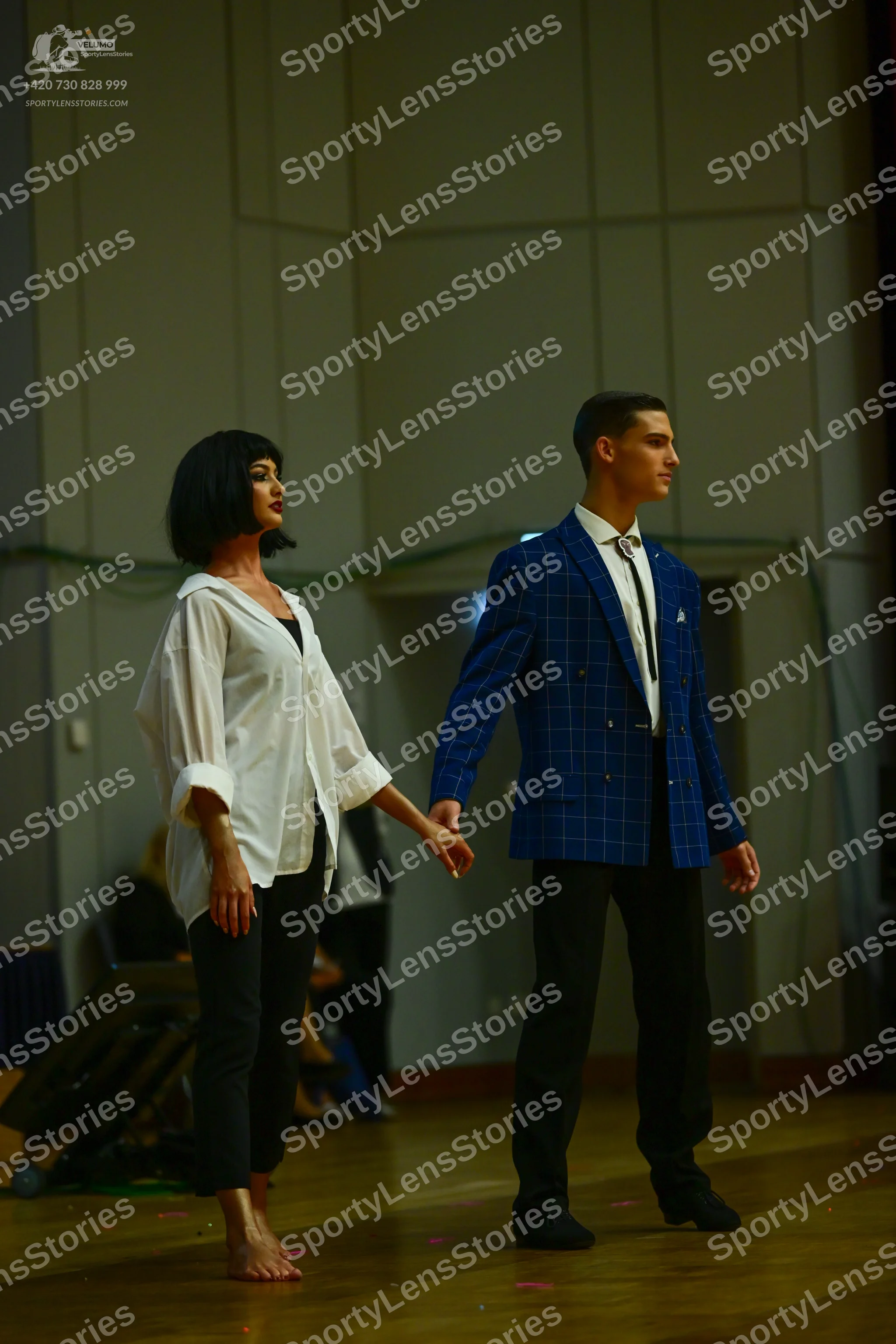 Dancesport competitor: Female dancer: white long-sleeved button-down shirt and black leggings