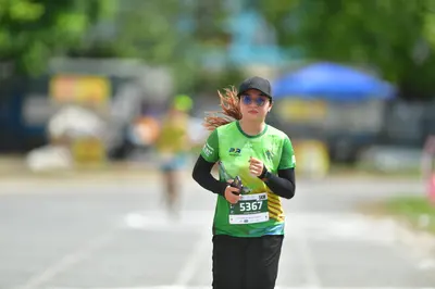 Marathon runner #5367: Runner 1: green and yellow jersey, black long sleeves, black pants, black cap, b