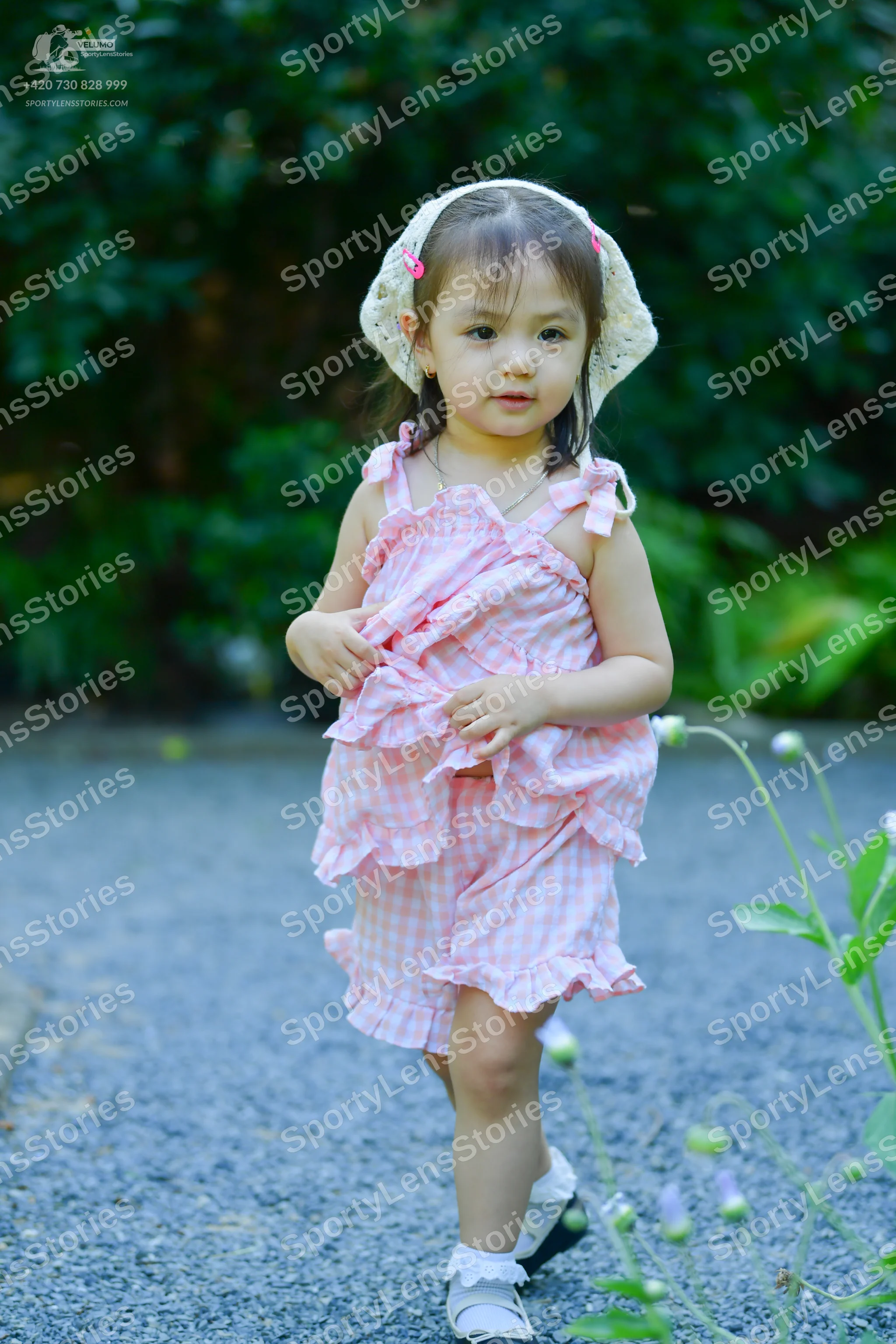 Dancesport competitor: Female dancer: pink and white gingham sleeveless top and shorts with ruffle trim