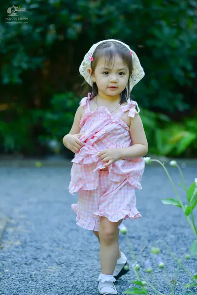 Dancesport competitor: Female dancer: pink and white gingham sleeveless top and shorts with ruffle trim