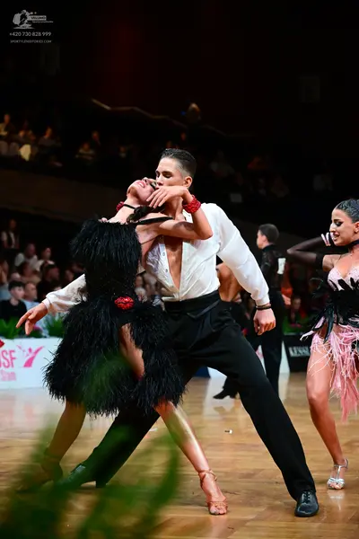 Dancesport competitor: Male dancer: white long-sleeved shirt and black trousers