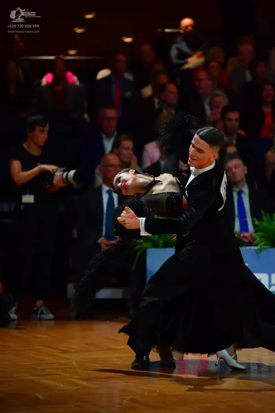 Dancesport competitor: Male dancer: black suit