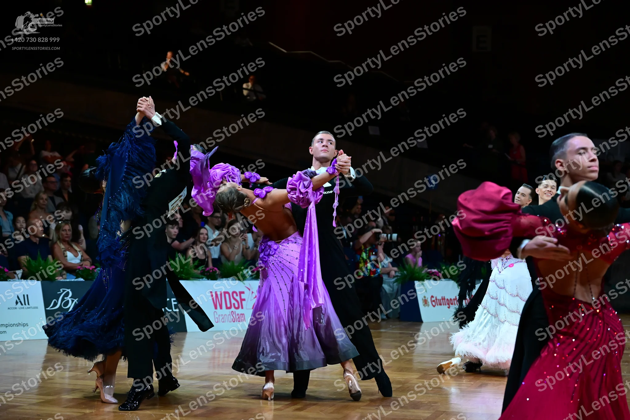 Dancesport competitor: Female dancer (left): navy blue ballroom gown