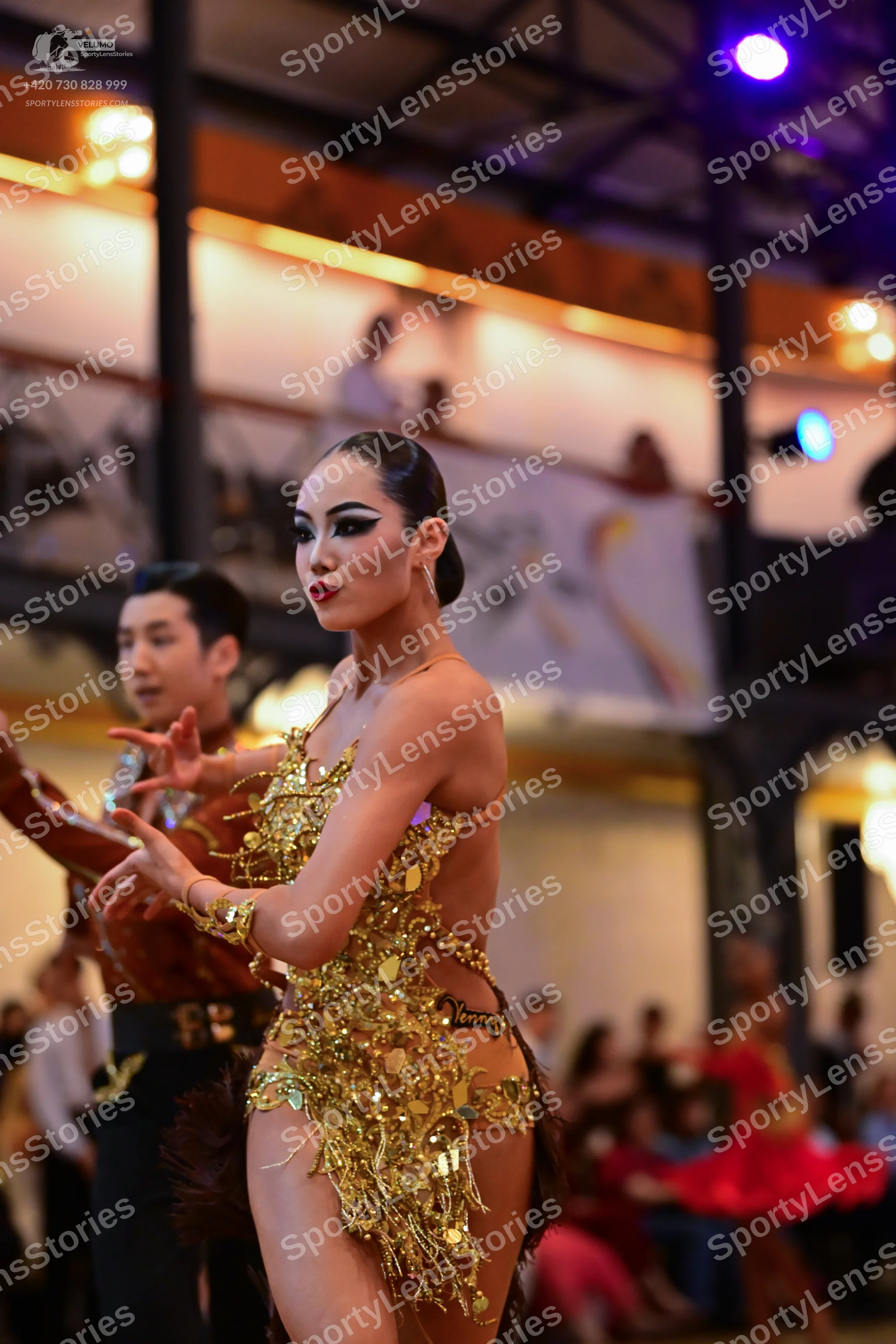 Dancesport competitor: Female dancer: gold latin dress with heavy sequin and metallic fringe embellishm