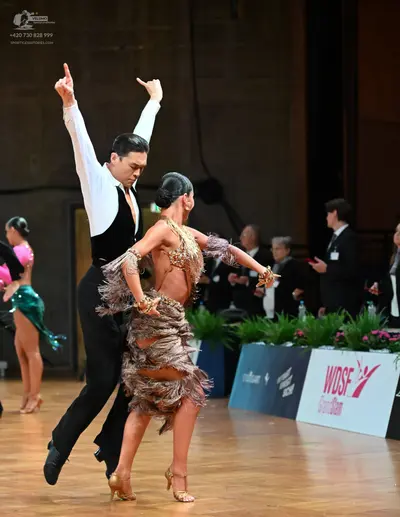 Dancesport competitor: Male dancer: white long-sleeved shirt, black waistcoat, and black trousers
