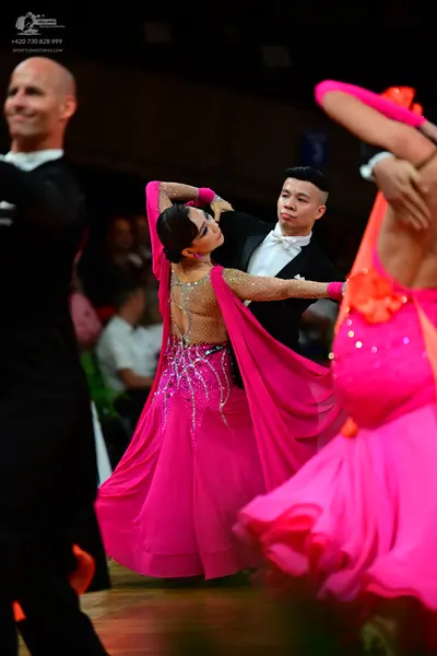 Dancesport competitor: Male dancers: black suits with white shirts and white bowties