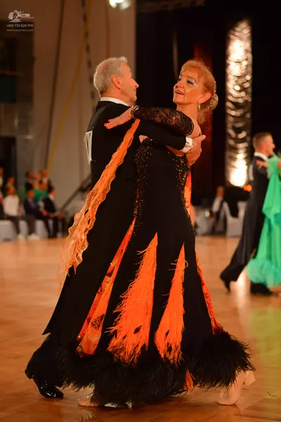 Dancesport competitor: Male dancer: black suit with a white shirt