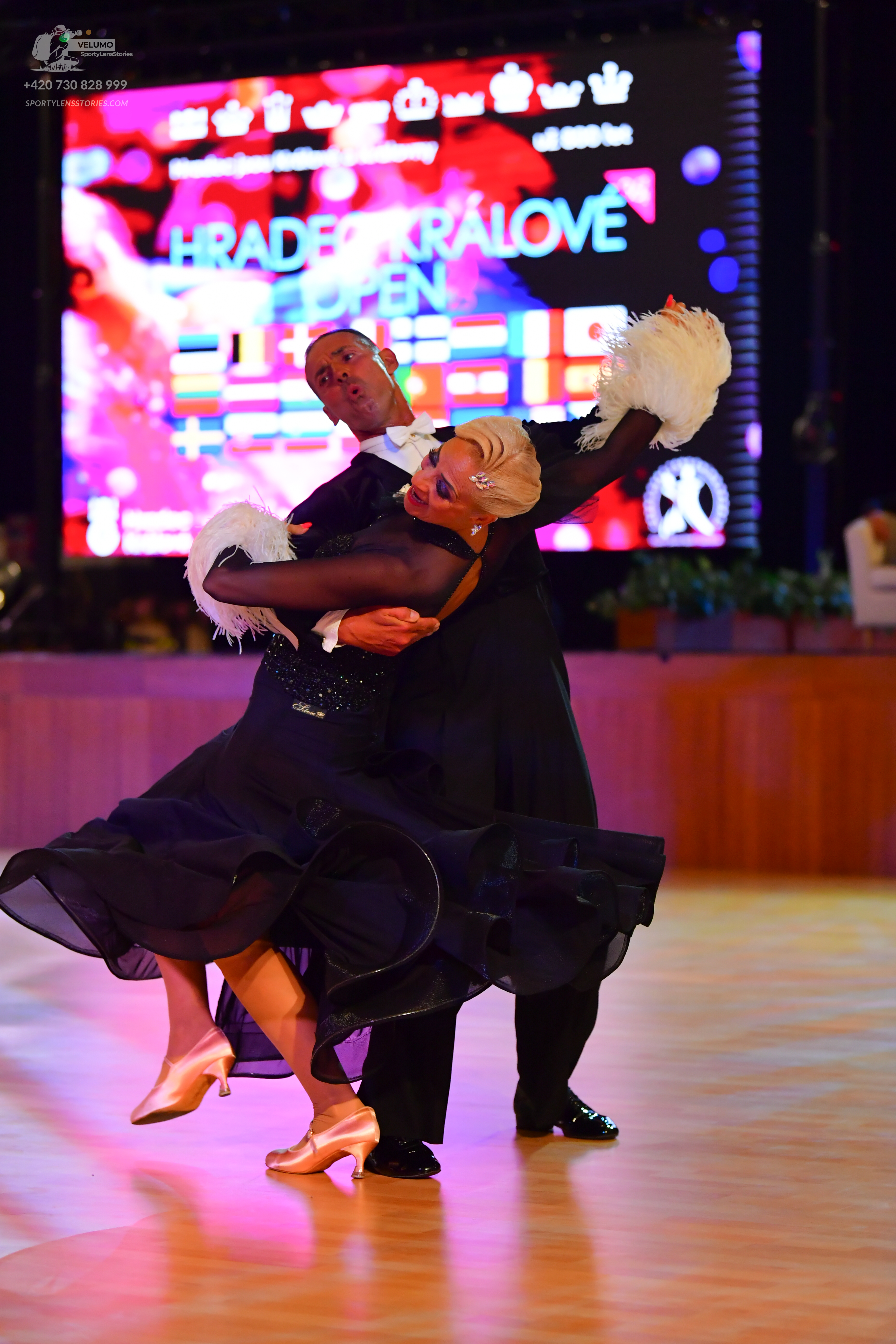 Dancesport competitor: Male:** Black suit with sequin lapels and tuxedo pants