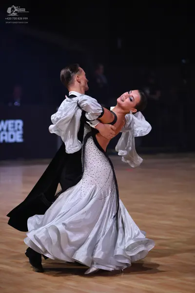 Dancesport competitor: Male dancer: black tailcoat with large, ruffled white sleeves