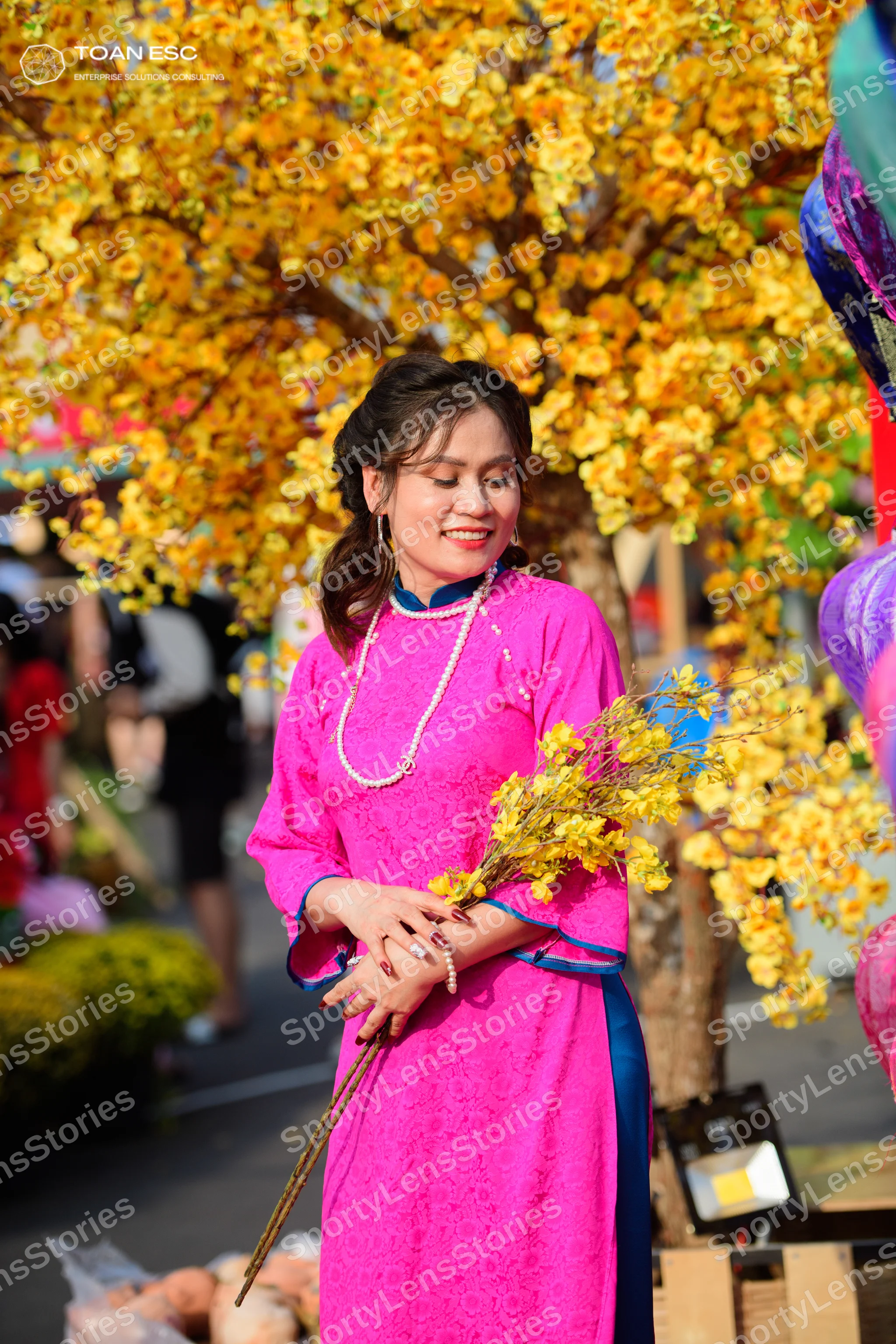Dancesport competitor: Female dancer: pink long-sleeved dress with blue trim and patterned lace fabric,