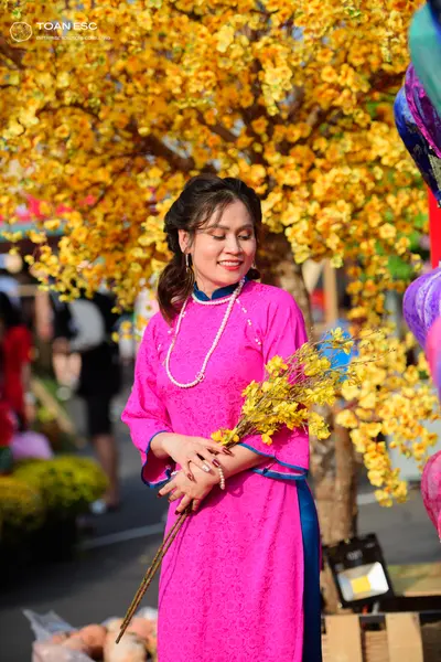 Dancesport competitor: Female dancer: pink long-sleeved dress with blue trim and patterned lace fabric,