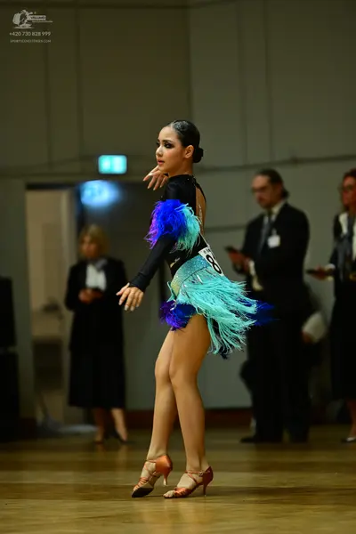Dancesport competitor #18: Female dancer: black long-sleeved Latin dance dress with a colorful fringe skirt