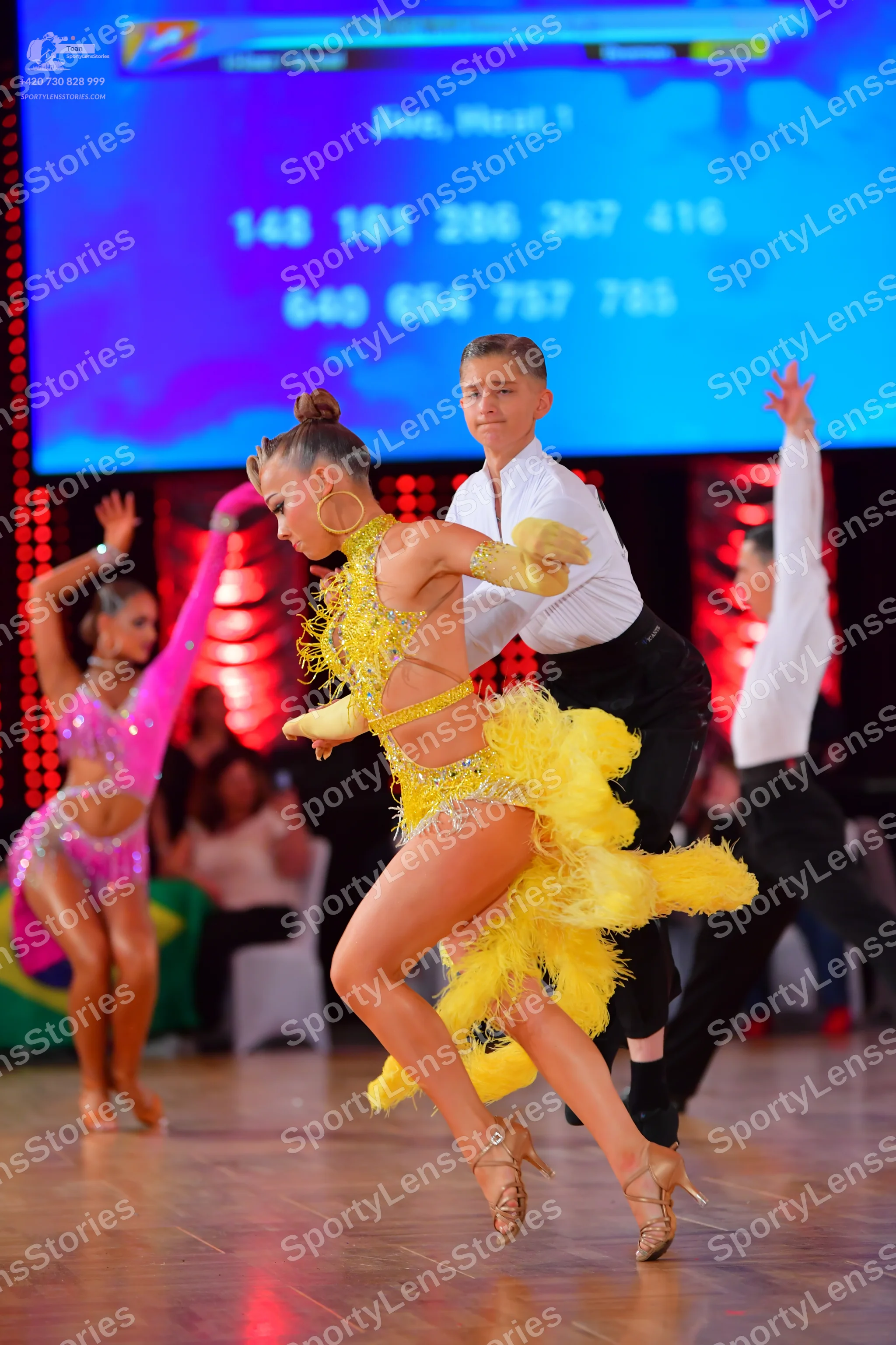 Dancesport competitor: Female dancer 1: pink latin dress with sequins and cut-outs